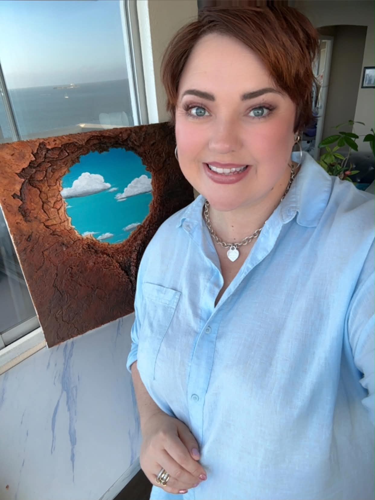 Kerianne Mellott in her studio, holding a piece from the Discovered series